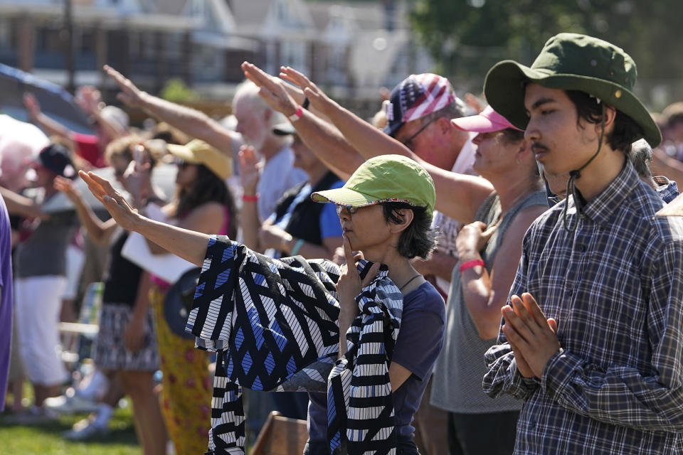 Attendees pray during a "rosary rally" on Sunday, Aug. 6, 2023, in Norwood, Ohio. A national religious organization, Catholics for Catholics, gathered a lineup of anti-abortion influencers and conspiracy theorists from across the U.S. to speak at the rally to urge a “yes” vote on a ballot question in Ohio, known as Issue 1. If voters approve Issue 1, it would make it more difficult for an abortion rights amendment on the November ballot to succeed. (AP Photo/Darron Cummings)