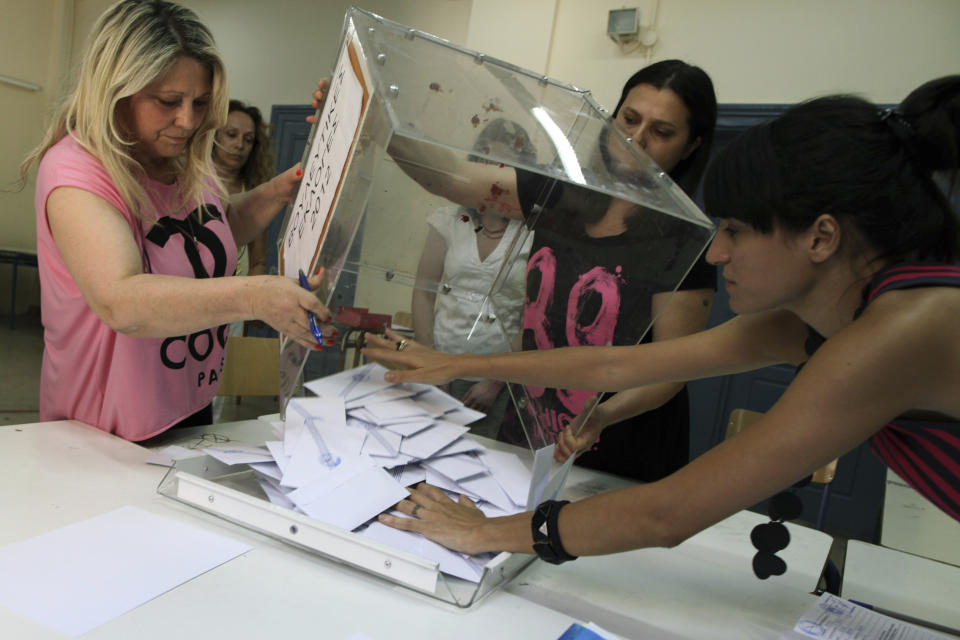 Election officials empty a ballot box to count votes during a parliamentary election at a polling station, in Athens, Sunday, June 17, 2012. Greeks are voting Sunday for the second time in six weeks in what is arguably their country's most critical election in 40 years. (AP Photo/Petros Giannakouris)