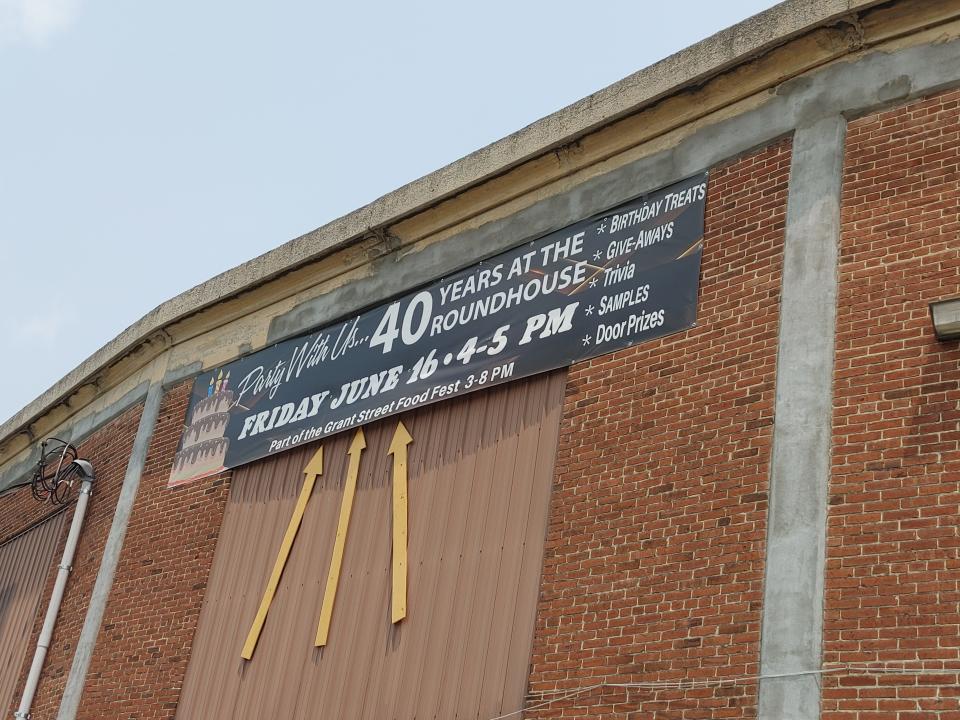 A sign outside of Jim's Farmers Market advertises an event to celebrate 40 years at a former railroad roundhouse.