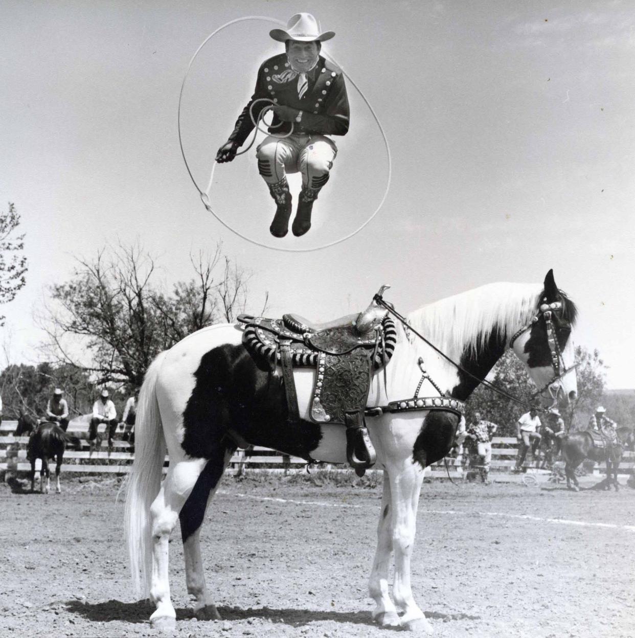 Montie Montana jumps through a hoop on horseback.