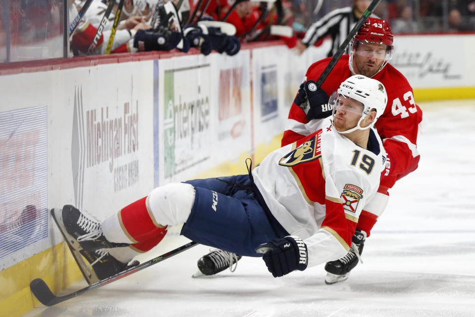 Detroit Red Wings left wing Darren Helm (43) checks Florida Panthers defenseman Mike Matheson (19) during the third period of an NHL hockey game Saturday, Jan. 18, 2020, in Detroit. (AP Photo/Paul Sancya)