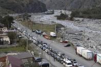 Cars queuing toward the border crossing at Verkhny Lars between Russia and Georgia, leaving Chmi, North Ossetia - Alania Republic, in Russia, Thursday, Sept. 29, 2022. Long lines of vehicles have formed at a border crossing between Russia's North Ossetia region and Georgia after Moscow announced a partial military mobilization. A day after President Vladimir Putin ordered a partial mobilization to bolster his troops in Ukraine, many Russians are leaving their homes. (AP Photo)