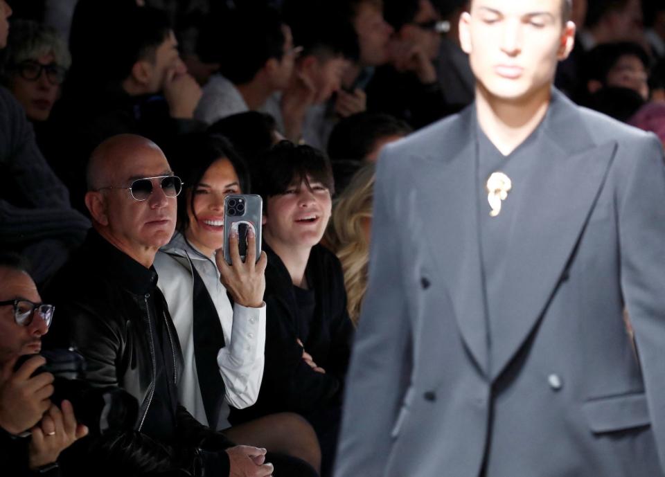 Jeff Bezos and Lauren Sánchez watch Nikko Gonzalez walk the Dolce & Gabbana runway.