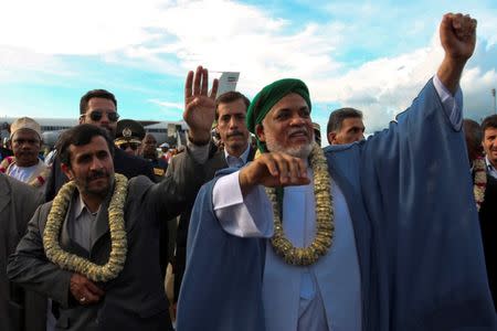 Iran's President Mahmoud Ahmadinejad (L) and Comoros President Ahmed Abdallah Mohamed Sambi wave to people at the airport of the Comorian capital of Moroni February 25. REUTERS/Stringer/Files