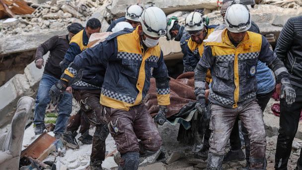 PHOTO: Members of the Syrian civil defence, known as the White Helmets, transport a casualty from the rubble of buildings in the village of Azmarin, Syria, on Feb. 7, 2023. (Omar Haj Kadour/AFP via Getty Images)