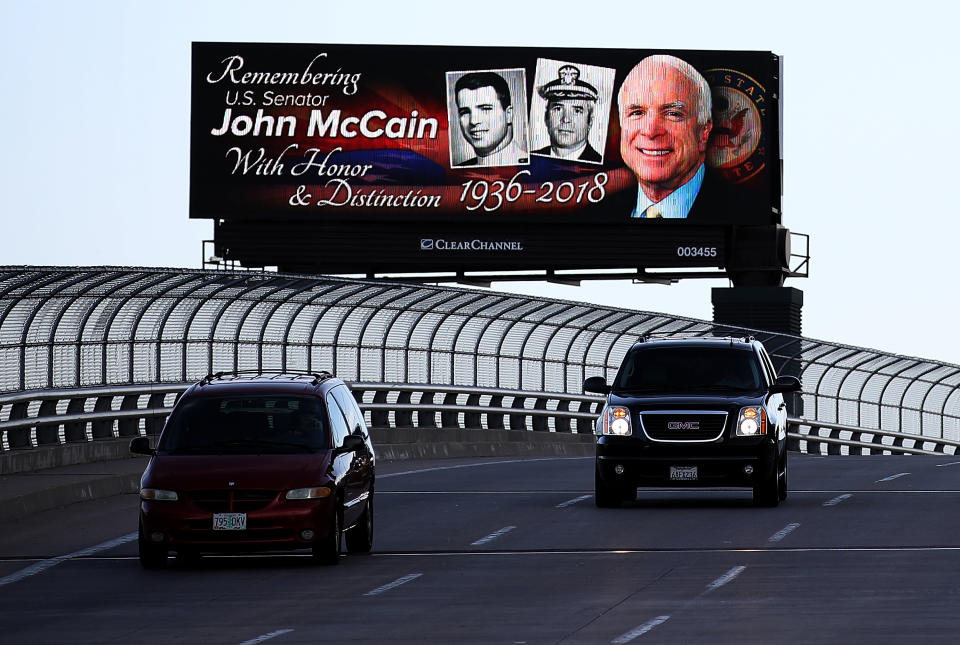 <p>Cars drive by a billboard with a message honoring Sen. John McCain (R-AZ) on Aug. 27, 2018 in Phoenix, Ariz. (Photo: Justin Sullivan/Getty Images) </p>