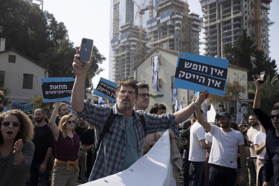 High-tech workers protest Israel's right-wing government in Tel Aviv, Tuesday, Israel, Jan. 24, 2023. As Israel's new government pushes ahead with its far-right agenda, the tech industry is speaking out in unprecedented criticism against policies it fears will drive away investors and decimate the booming sector, Israel. Hebrew reads: "No democracy, no high tech."(AP Photo/ Maya Alleruzzo)