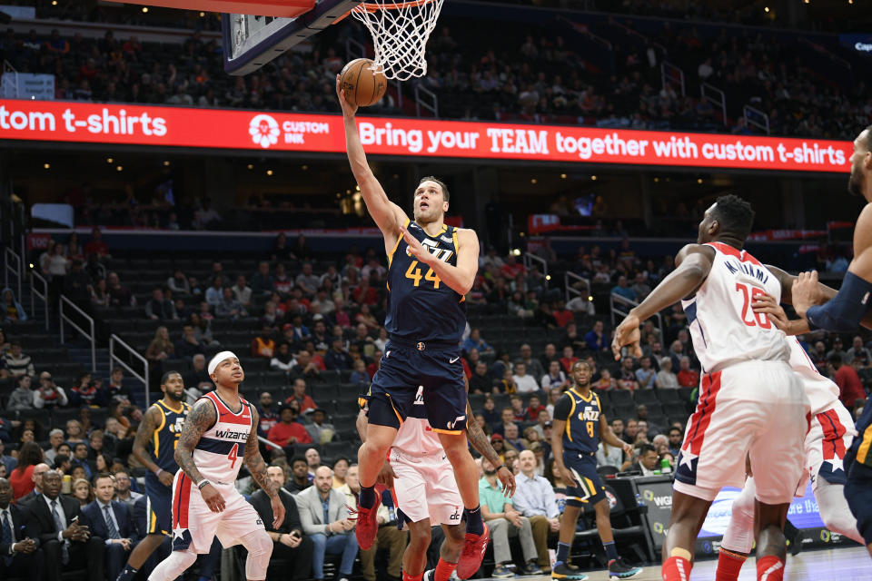 Utah Jazz forward Bojan Bogdanovic (44) goes to the basket against Washington Wizards guard Isaiah Thomas (4) and center Ian Mahinmi (28) during the first half of an NBA basketball game, Sunday, Jan. 12, 2020, in Washington. (AP Photo/Nick Wass)