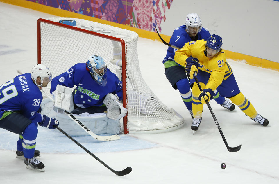 Sweden forward Loui Eriksson (21) looks to pass against Slovenia defenseman Klemen Pretnar (7) in the first period of a men's quarterfinal ice hockey game at the 2014 Winter Olympics, Wednesday, Feb. 19, 2014, in Sochi, Russia. (AP Photo/Mark Humphrey)