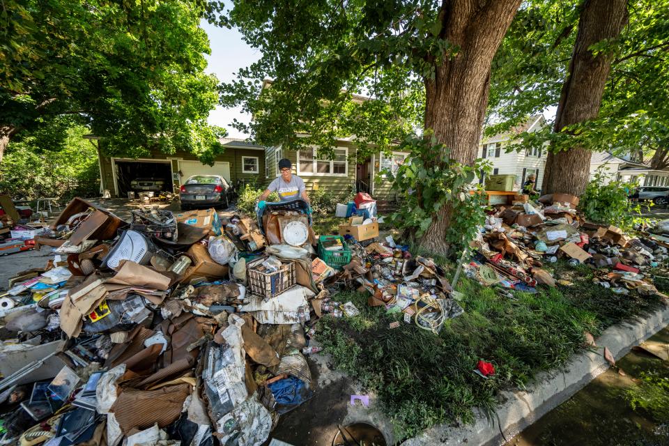 Cindy Osborne of Polk City helps clean out a family member's home as floodwaters recede in Rock Valley, Monday, June 24, 2024.