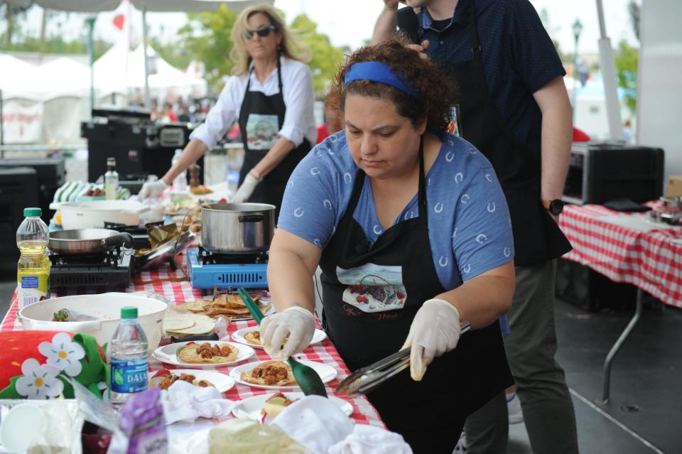 In this file photo, Elizabeth Koseyan, of North Hills, cooks her strawberry-marinated Yucatan pork tostadas with fresh strawberry corn salsa and avocado cream at the California Strawberry Festival.