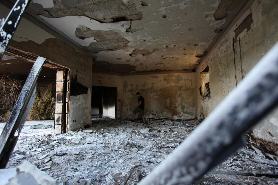 FILE - This Sept. 13, 2012 file photo shows a man walking in the rubble of the damaged U.S. consulate, after an attack that killed four Americans, including Ambassador Chris Stevens on the night of Tuesday, Sept. 11, 2012, in Benghazi, Libya. A retired general who was in the U.S. military’s operation center during the 2012 attack on the diplomatic outpost in Benghazi, Libya, said Thursday that Washington should have done more to respond during the battle. (AP photo/Mohammad Hannon, File)