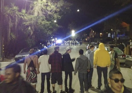 This video image provided by KEYT-TV shows a crowd confronting police at a disturbance Saturday April 5, 2014, during a weekend college party in Southern California that devolved into a street brawl. About 100 people were arrested and at least 44 people were taken to the hospital. (AP Photo/KEYT-TV)