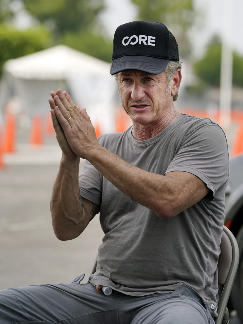 Actor Sean Penn, founder of Community Organized Relief Effort (CORE), is interviewed at a CORE coronavirus testing site at Crenshaw Christian Center, Friday, Aug. 21, 2020, in Los Angeles. Penn says his organization CORE has made some strides against the coronavirus and he's keeping its mission going by expanding testing and other relief services. (AP Photo/Chris Pizzello)