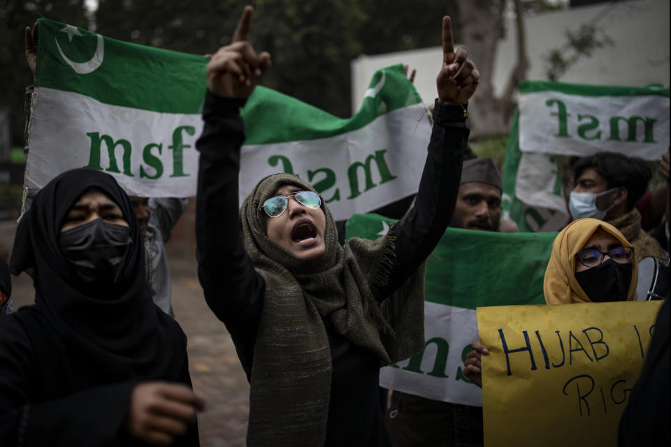 FILE - An Indian Muslim woman shouts slogans during a protest against barring Muslim girls wearing hijab from attending classes at some schools in the southern Indian state of Karnataka, in New Delhi, India, Tuesday, Feb. 8, 2022. A court in the southern state on Tuesday, March 15, has upheld the ban on wearing hijab in schools and colleges, saying the Muslim headscarf is not an essential religious practice of Islam. (AP Photo/Altaf Qadri, File)