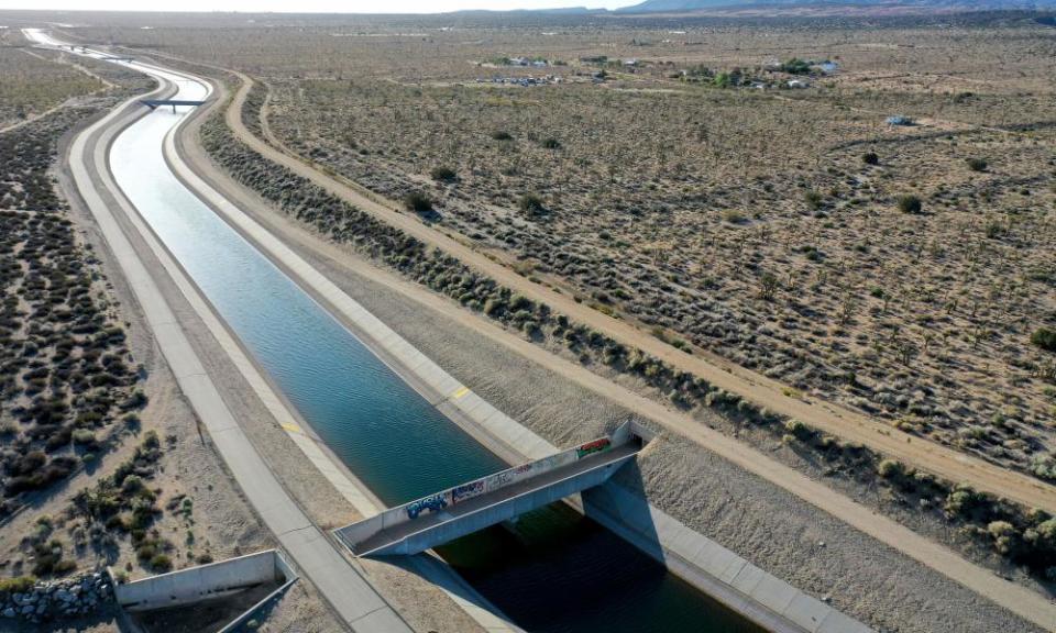 An aqueduct carrying water through a desert.