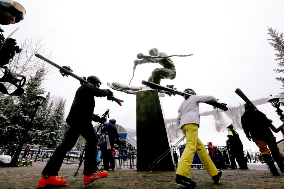 Skiers catch a gondola in Vail Village at the foot of Vail Mountain, the largest ski resort area in Colorado.