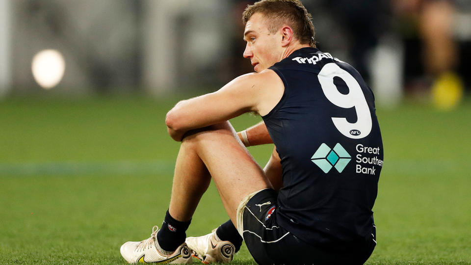 Patrick Cripps sits on the ground after Carlton's loss to Collingwood.