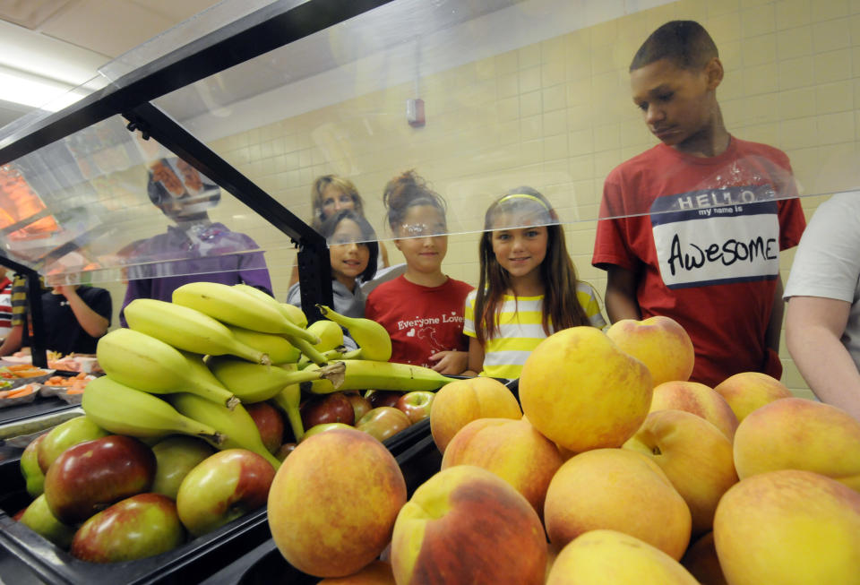 Students select food items from the lunch line of the cafeteria at Draper Middle School in Rotterdam, N.Y., Tuesday, Sept. 11, 2012. The leaner, greener school lunches served under new federal standards are getting mixed grades from students. (AP Photo/Hans Pennink)