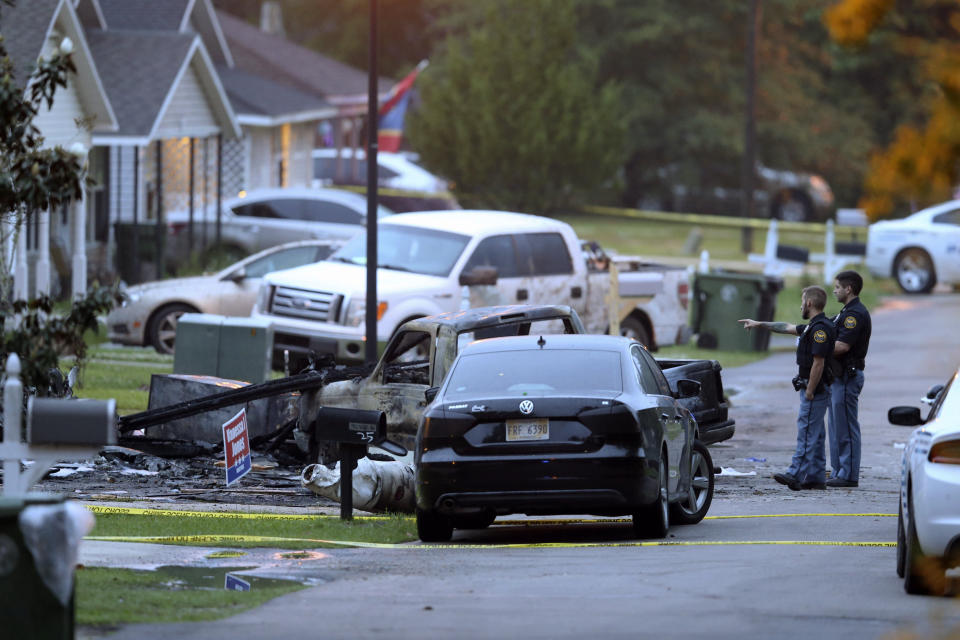 Hattiesburg police surround a burned automobile and a damaged home after a small plane crashed late Tuesday night in Hattiesburg, Miss., Wednesday May 5, 2021. Emergency officials in Mississippi say multiple people were killed when the small plane crashed into a home. (AP Photo/Chuck Cook)