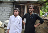 Gul Faraz, right, and Rizwan Ullah, survivors of cable car incident, talk to members of media, near the incident site, in Pashto village, a mountainous area of Battagram district in Pakistan's Khyber Pakhtunkhwa province, Wednesday, Aug. 23, 2023. The rescue of six school children and two adults who were plucked from a broken cable car that was dangling precariously hundreds of meters (yards) above a steep gorge was a miracle, a survivor said Wednesday. The teenager said he and the others felt repeatedly that death was imminent during the 16-hour ordeal. (AP Photo/Saqib Manzoor)
