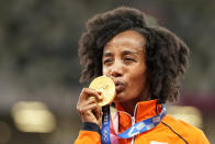 Gold medalist Sifan Hassan, of Netherlands, kisses her medal during the medal ceremony for the women's 10,000-meters at the 2020 Summer Olympics, Saturday, Aug. 7, 2021, in Tokyo. (AP Photo/Martin Meissner)