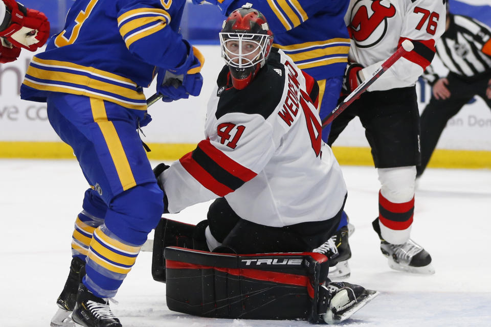 CORRECTS ID TO SCOTT WEDGEWOOD (41), NOT MACKENZIE BLACKWOOD (29) - New Jersey Devils goalie Scott Wedgewood (41) makes a save during the second period of an NHL hockey game against the Buffalo Sabres, Saturday, Jan. 30, 2021, in Buffalo, N.Y. (AP Photo/Jeffrey T. Barnes)