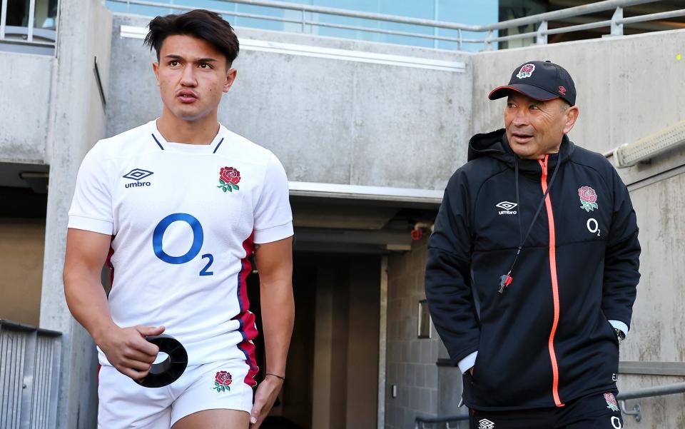 Marcus Smith with England head coach Eddie Jones - Marcus Smith insists sport must offer a distraction to cost of living crisis - GETTY IMAGES