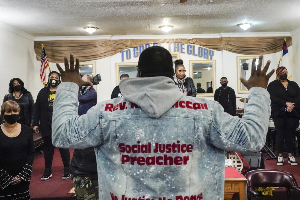 The Rev. Kevin McCall leads a prayer before a recording session for an album of protest songs Monday, Dec. 28, 2020, in New York. A full album of songs is set for release in May, one year after George Floyd’s death at the hands of police in Minneapolis. Terrence Floyd, the brother of George Floyd, was recruited for the project by McCall, who said he believes an album of street-inspired protest anthems does not yet exist. (AP Photo/Frank Franklin II)