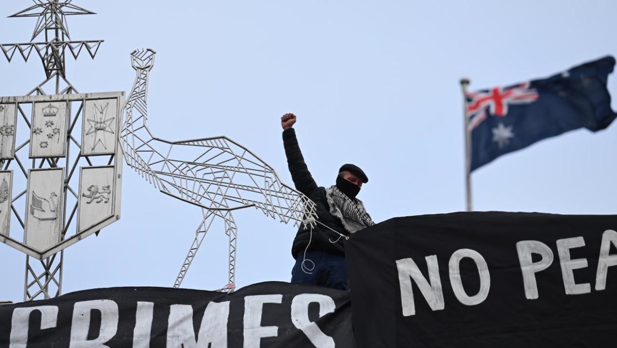 Pro-Palestine protesters have taken to the roof of Parliament House to unfurl a banner. Picture: NewsWire/ Martin Ollman