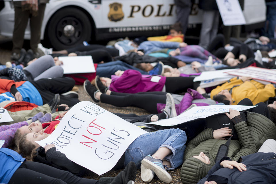 Students and supporters&nbsp;hold signs as they protest outside the White House.