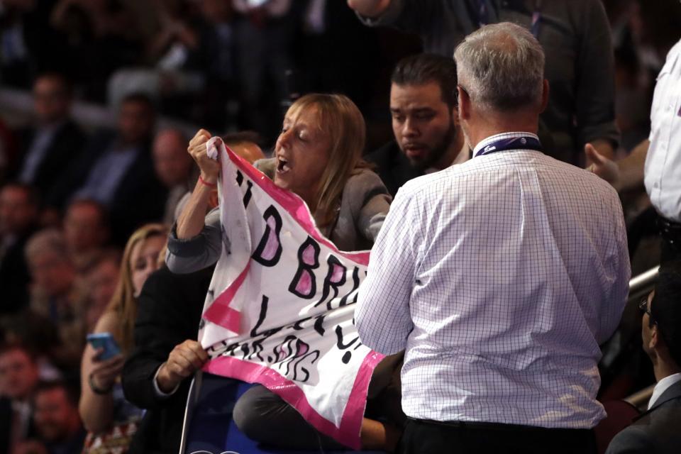 Protester Medea Benjamin of Code Pink is taken away as Donald Trump speaks on the final day of the Republican National Convention. (Photo: Matt Rourke/AP)