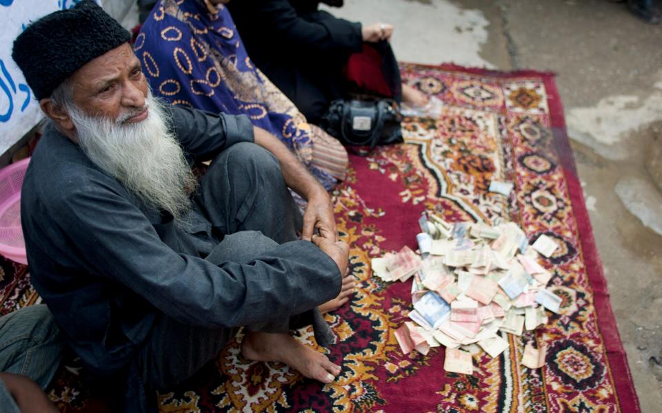 Abdul Sattar Edhi collects donations at a roadside in Peshawar, Pakistan.  - Credit: Anjum Naveed