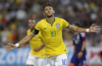 Brazil&#39;s Neymar celebrates after scoring his fourth goal against Japan during an international friendly soccer match in Singapore, Tuesday, Oct. 14, 2014. (AP Photo/Wong Maye-E)