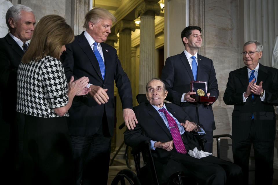 President Donald Trump greets former Senate Majority Leader Bob Dole as House Speaker Paul Ryan holds a Congressional Gold Medal during a ceremony at the Capitol, in Washington on Jan. 17, 2018.