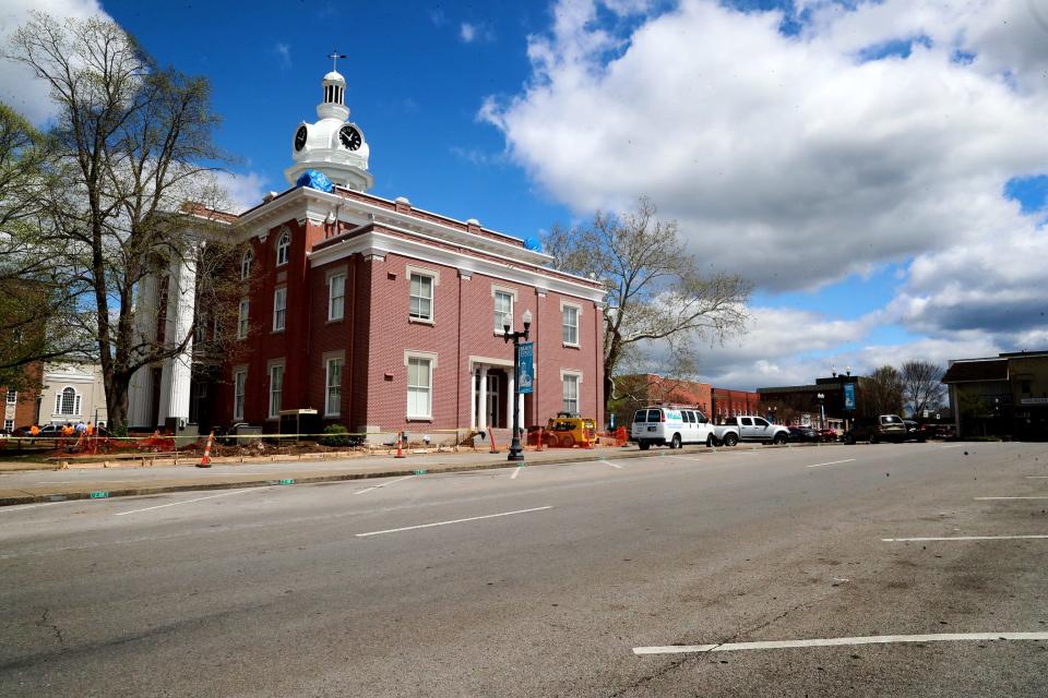 Little activity and several empty parking spots are seen midday near the Historic Rutherford County Courthouse on Wednesday, April 1, 2020, at the public square in Murfreesboro, Tenn.