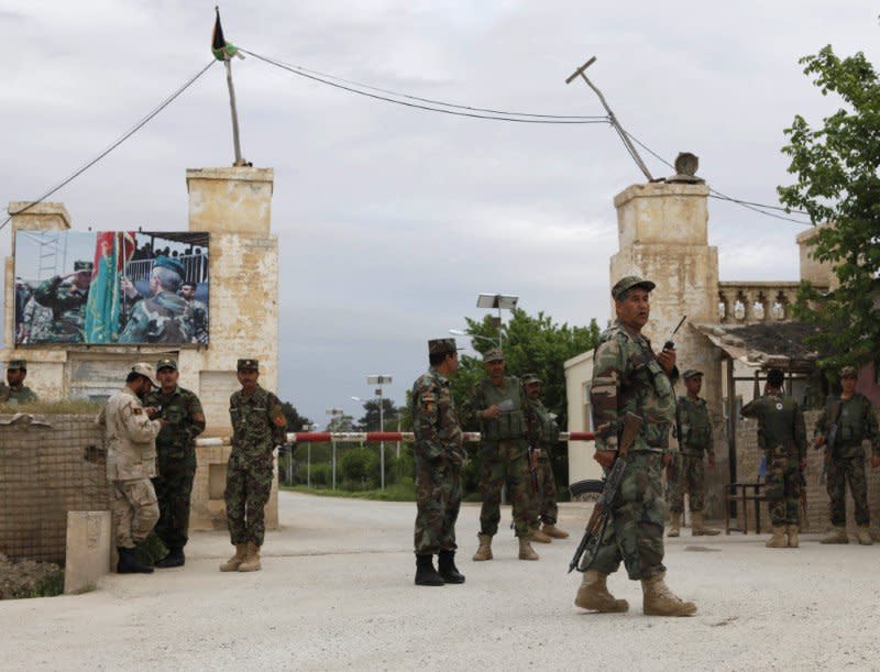 Afghan national Army (ANA) troops keep watch near the site of an ongoing attack on an army headquarters in Mazar-i-Sharif, northern Afghanistan April 21, 2017. REUTERS/Anil Usyan