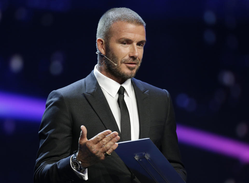 UEFA President's Award winner David Beckham gestures as he speaks on stages during for the UEFA Champions League draw at the Grimaldi Forum, in Monaco, Thursday, Aug. 30, 2018. (AP Photo/Claude Paris)