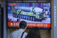 People watch a TV screen showing a news program reporting about North Korea's missiles with file footage in Seoul, South Korea, Wednesday, Sept. 15, 2021. North Korea fired two ballistic missiles into waters off its eastern coast Wednesday afternoon, two days after claiming to have tested a newly developed missile in a resumption of its weapons displays after a six-month lull. The letters read "North Korea fired two ballistic missiles." (AP Photo/Lee Jin-man)