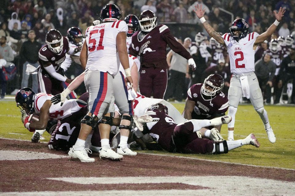 Mississippi running back Snoop Conner (24) scores on a 1-yard rush as Mississippi quarterback Matt Corral (2) reacts during the first half of an NCAA college football game against Mississippi State, Thursday, Nov. 25, 2021, in Starkville, Miss. (AP Photo/Rogelio V. Solis)