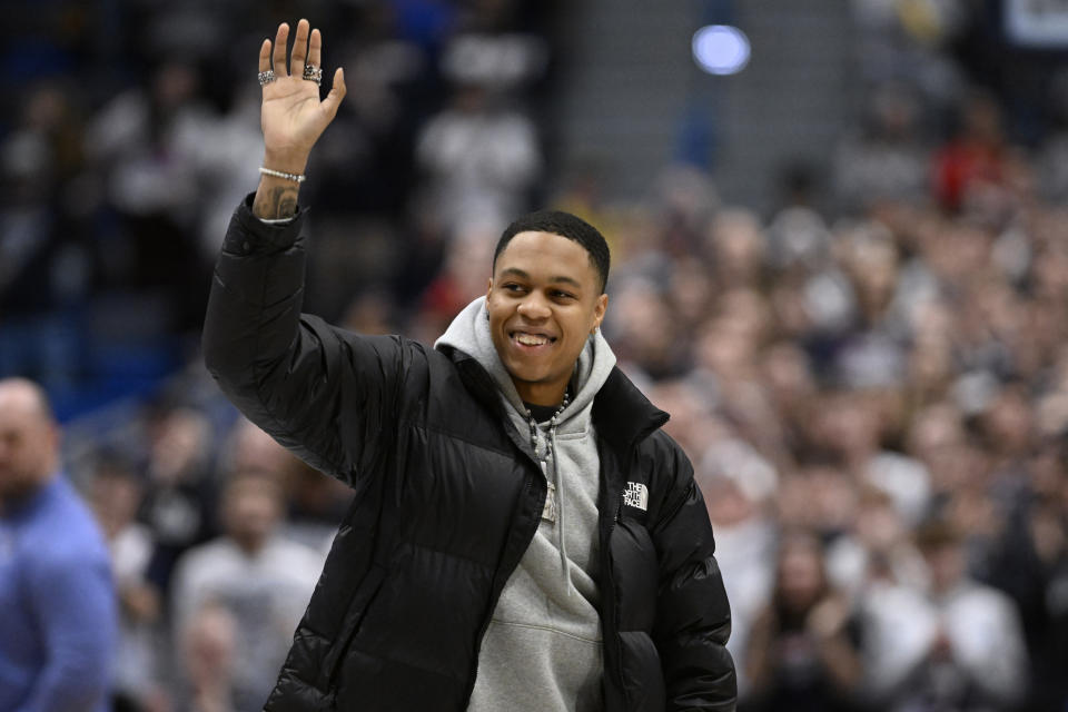 Former UConn player and NBA player Jordan Hawkins waves to spectators during an NCAA college basketball game between UConn and Xavier, Sunday, Jan. 28, 2024, in Hartford, Conn. (AP Photo/Jessica Hill)