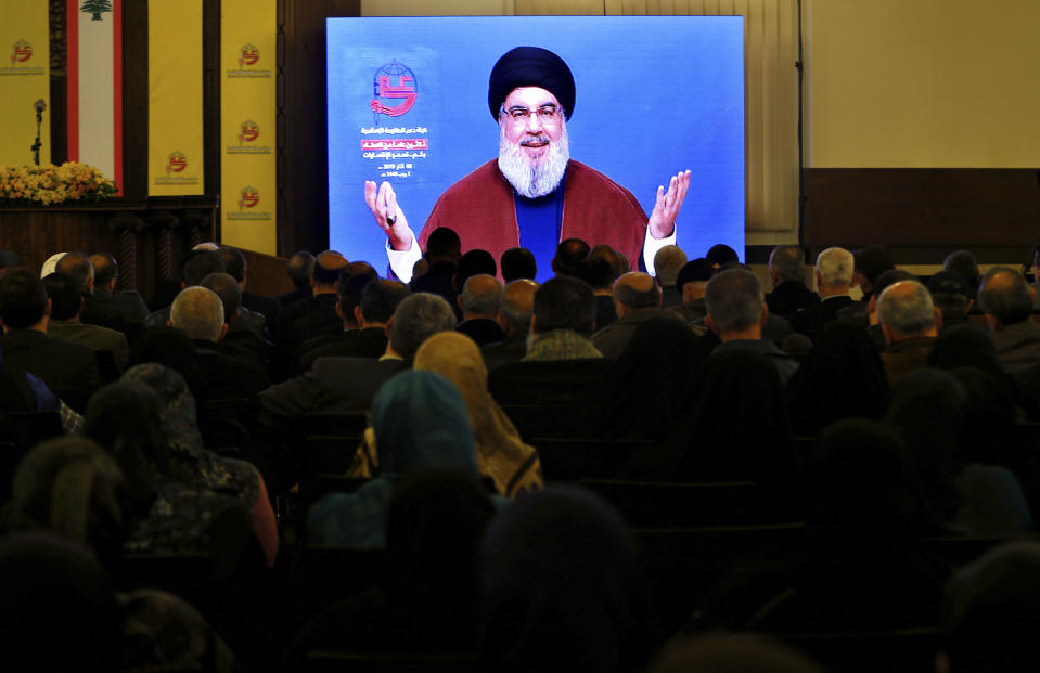 Supporters of the Iranian-backed Hezbollah group listen to a speech of Hezbollah leader Sayyed Hassan Nasrallah, via a video link, in a southern suburb of Beirut, Lebanon, Friday, March 8, 2019. Nasrallah called on his supporters to donate funds to the group as it comes under tighter sanctions from western countries. (AP Photo/Bilal Hussein)