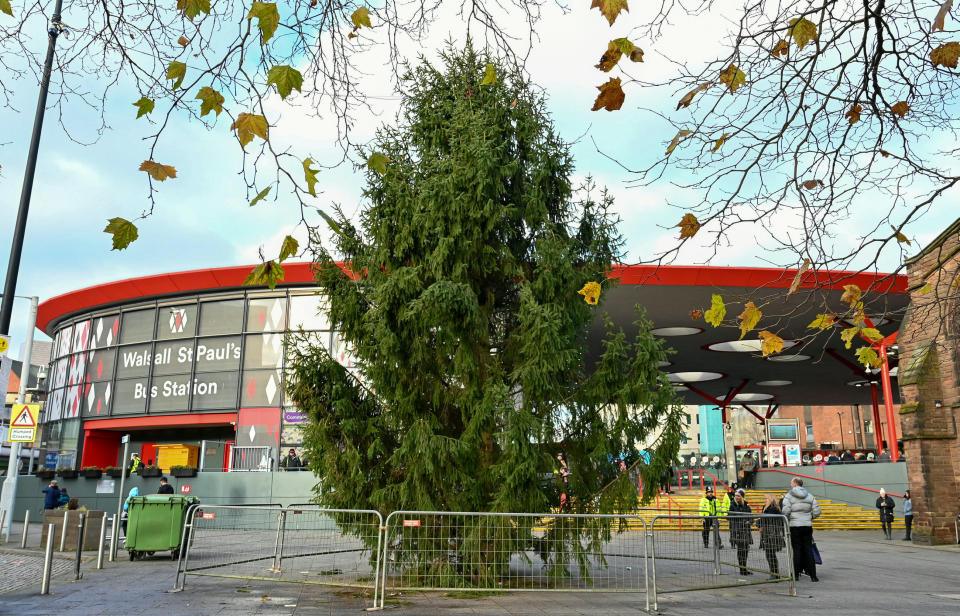 The Christmas tree, near to Walsall St Paul's Bus Station, was put up with barely any Christmas lights. (SWNS)