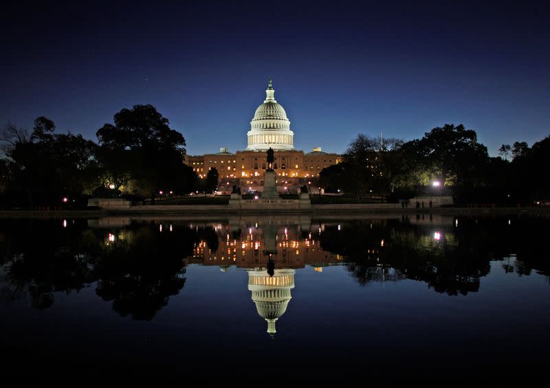 FILE PHOTO: The United States Capitol Building is reflected in the water at sunrise in Washington