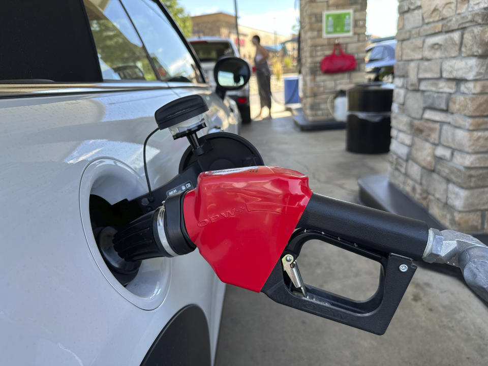 A motorist fills up the gasoline tank of a vehicle at a Costco warehouse Thursday, Aug. 22, 2024, in Parker, Colo. (AP Photo/David Zalubowski)