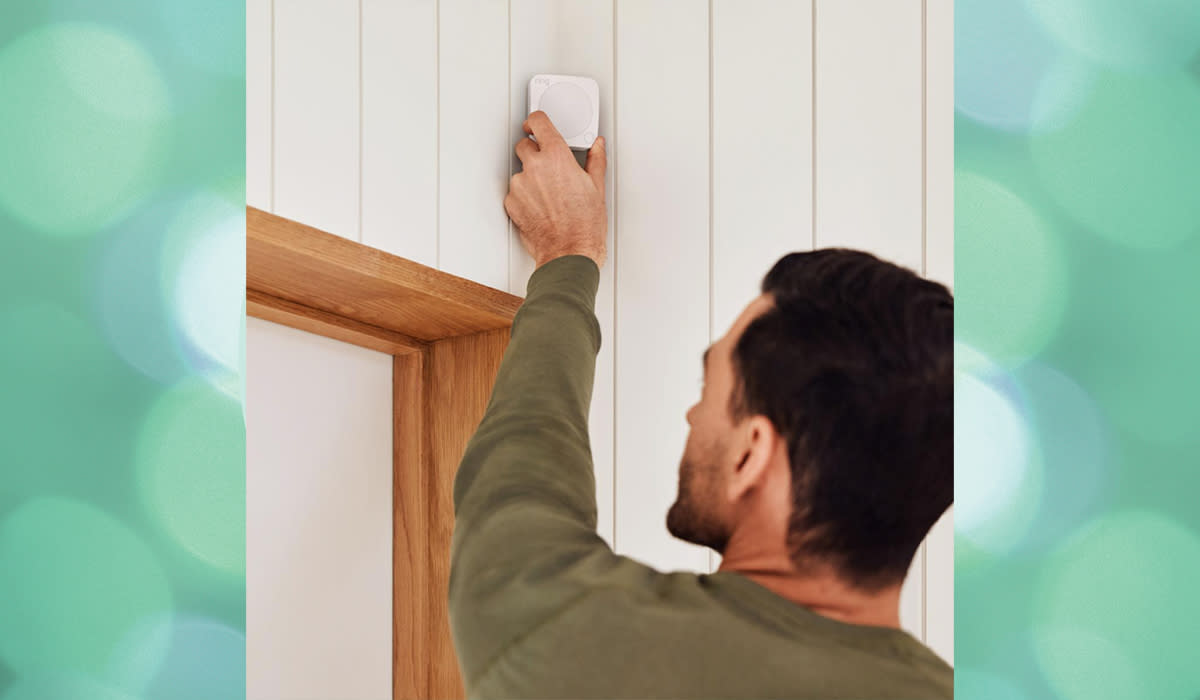 Man installing motion sensor alarm