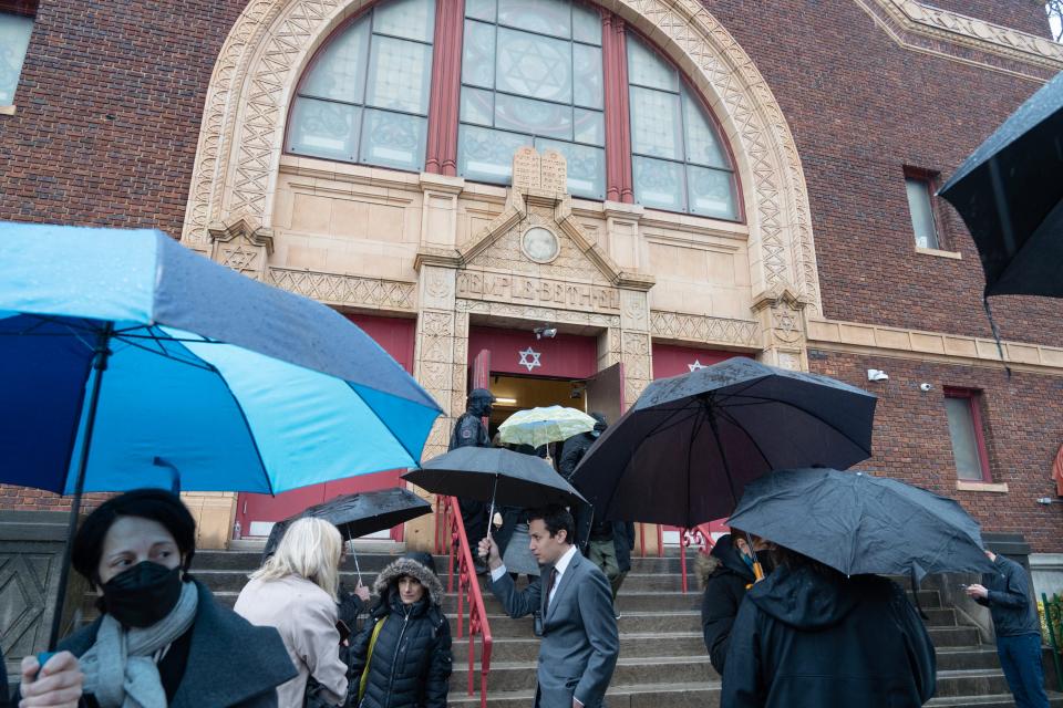 Mourners leave from the funeral of Alain Mentha, a Jersey City resident who founded a refugee support agency, Welcome Home Jersey City. The funeral was held at Temple Beth El in Jersey City, N.J. on Tuesday Jan. 3, 2023.