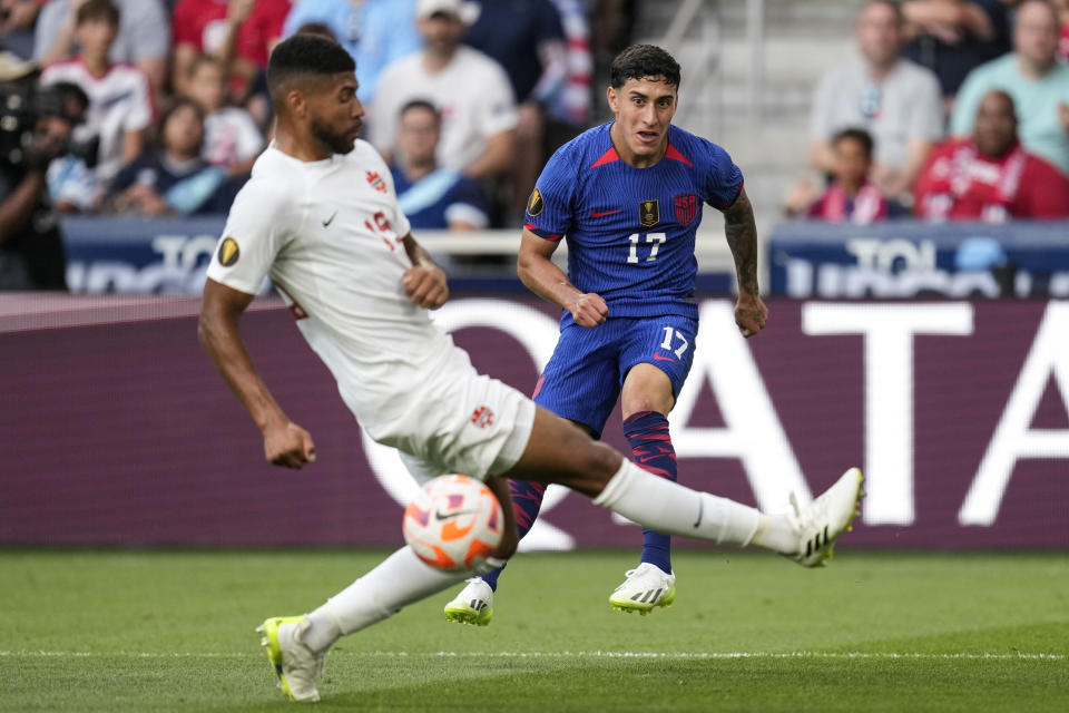 Canada defender Zac McGraw (15) tries a block against United States forward Alejandro Zendejas (17) during a CONCACAF Gold Cup semi-final soccer match, Sunday, July 9, 2023, in Cincinnati. (AP Photo/Michael Conroy)