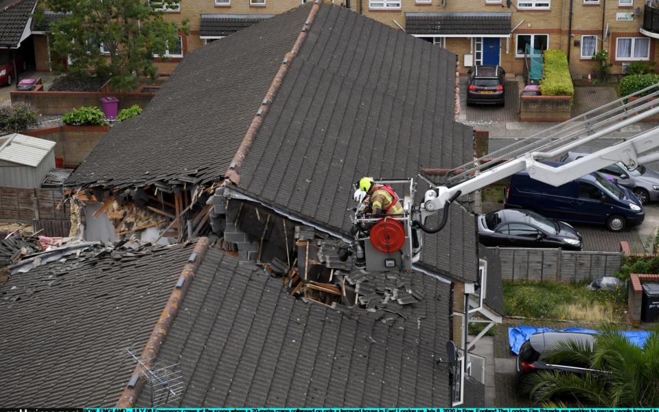 Rescuers work to free people trapped inside the terraced houses - Chris J Ratcliffe/Getty Images Europe