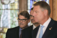 U.S. Energy Secretary Rick Perry, left, arrives for press statements along with Romanian President Klaus Iohannis, right, and Polish Prime Minister Mateusz Morawiecki, center, at the Three Seas Initiative Business Forum in Bucharest, Romania, Tuesday, Sept. 18, 2018. U.S. President Donald Trump has reaffirmed Washington's support for a business summit that aims to boost connectivity in Eastern Europe and improve ties between the region and the U.S. and European Union. (AP Photo/Vadim Ghirda)